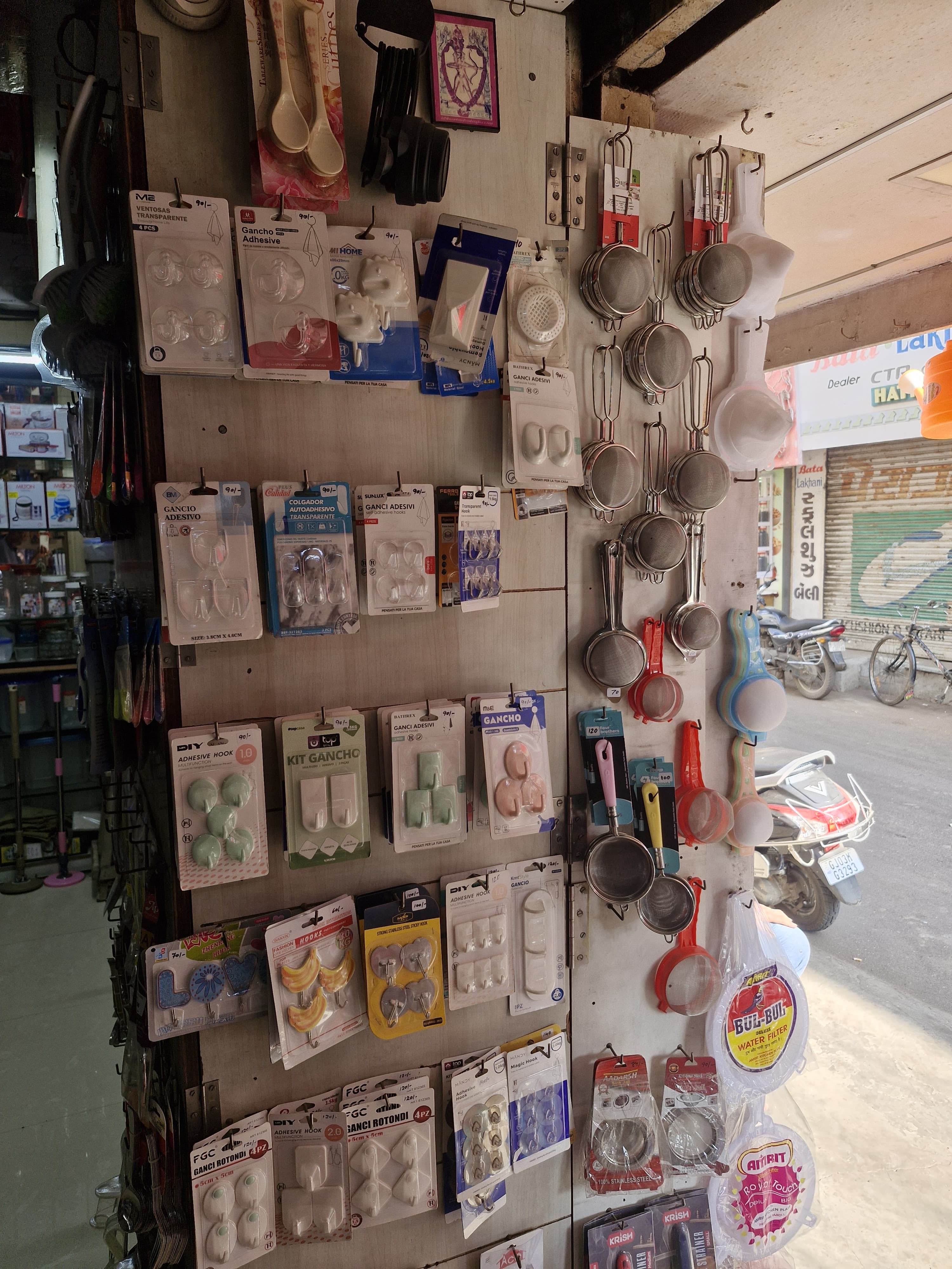 Wall display of kitchen utensils, tools, and gadgets organized on pegboard